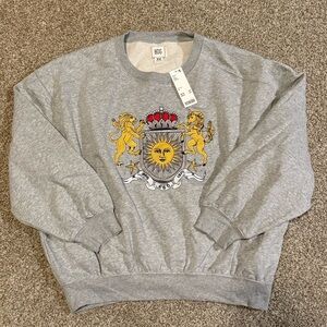 NWT Urban Outfitters Embroidered Sweater with Sun Design Royal Crest Nature
